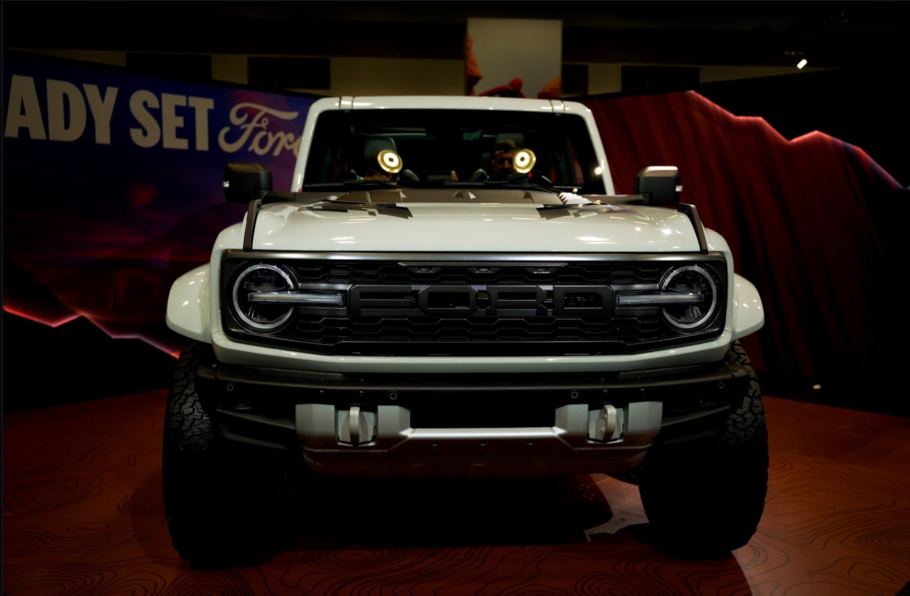 A truck on a dark showroom floor, graded in Chroma