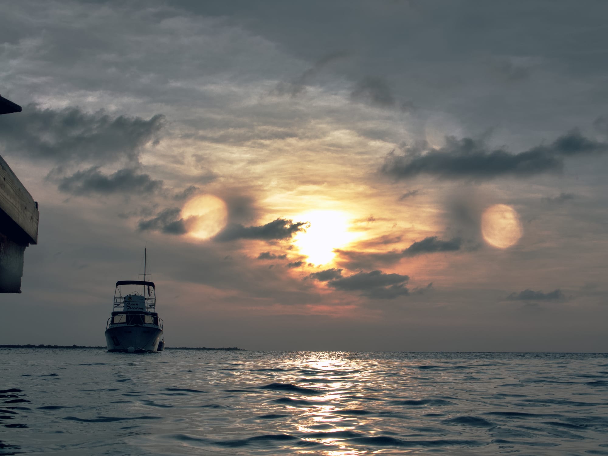 A boat at sea beneath a clouded sunset, made to feel the way the moment did